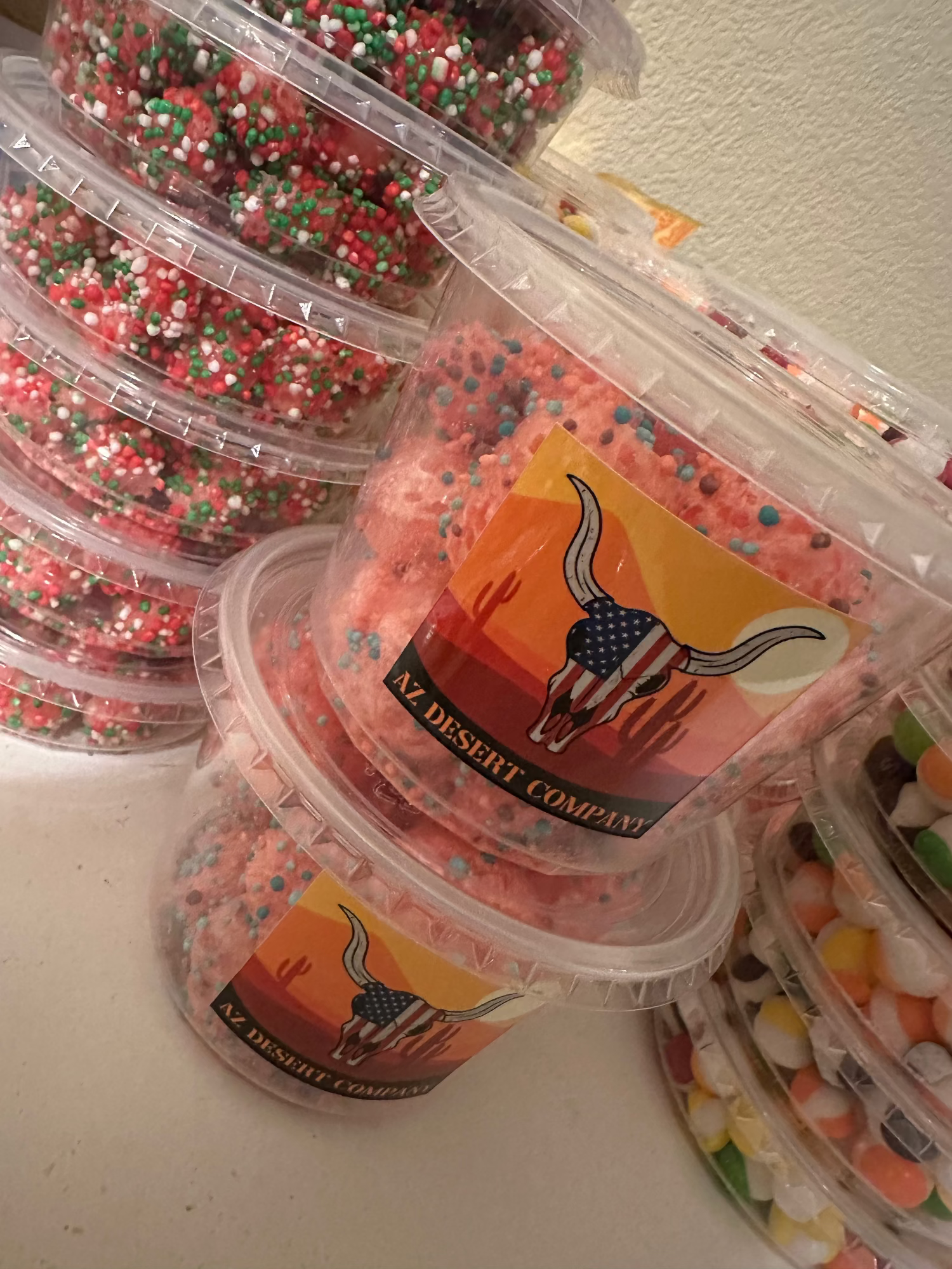 Containers of freeze dried nerdz gummy clusters with a visible brand logo on a white surface