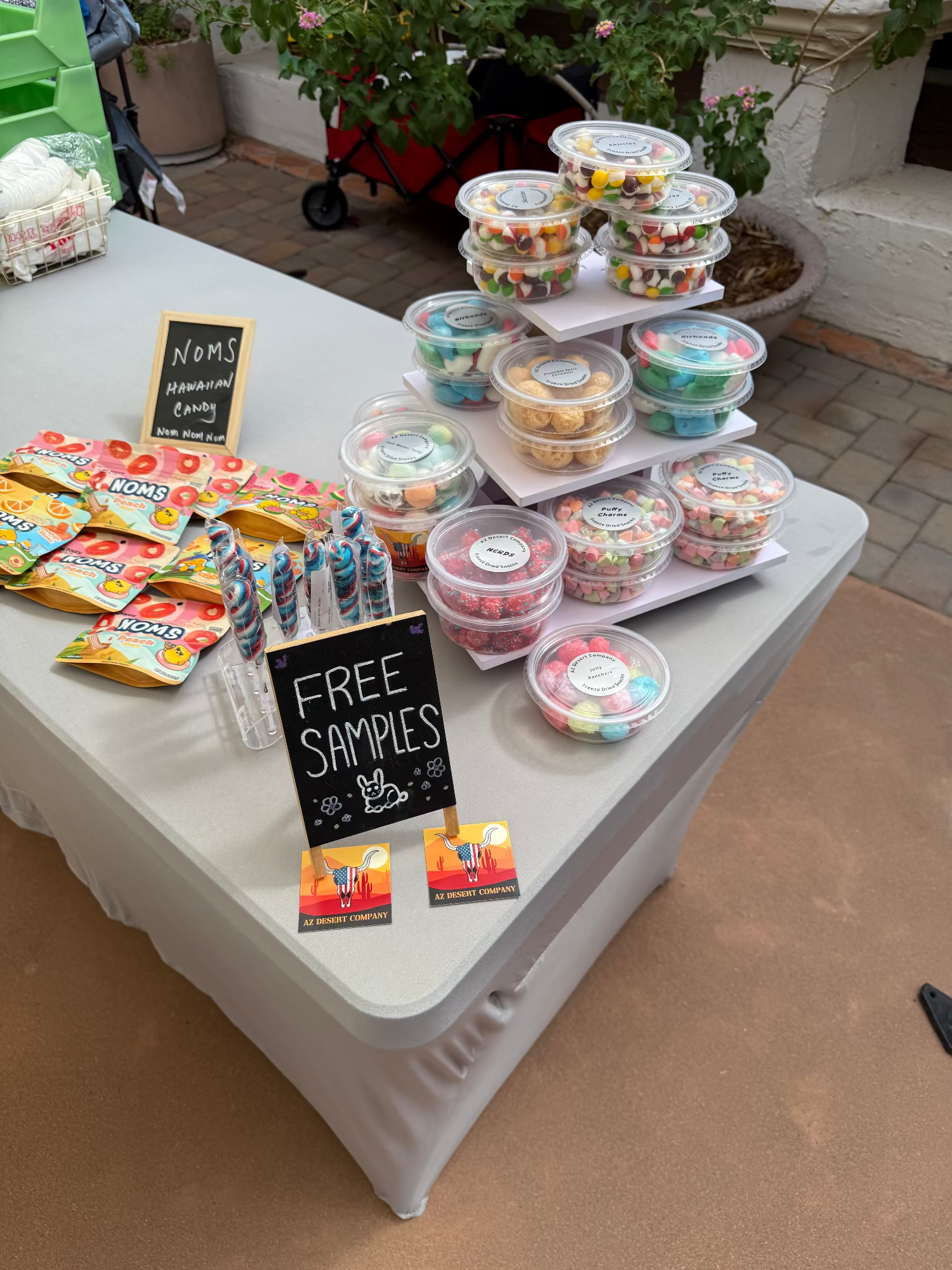 Table with freeze dried candy and free samples sign outdoors