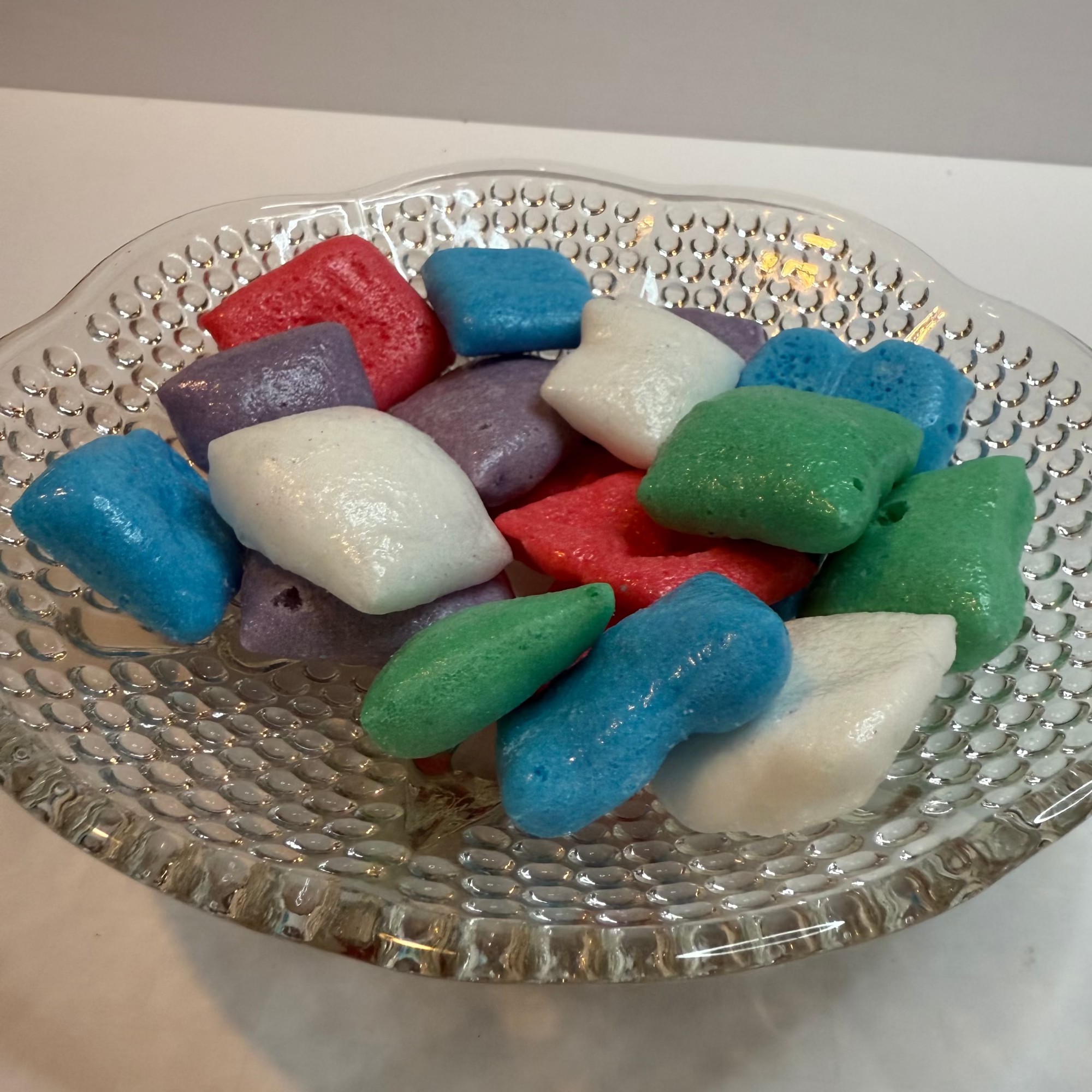 Freeze dried airheadz on a decorative glass plate with a plain background