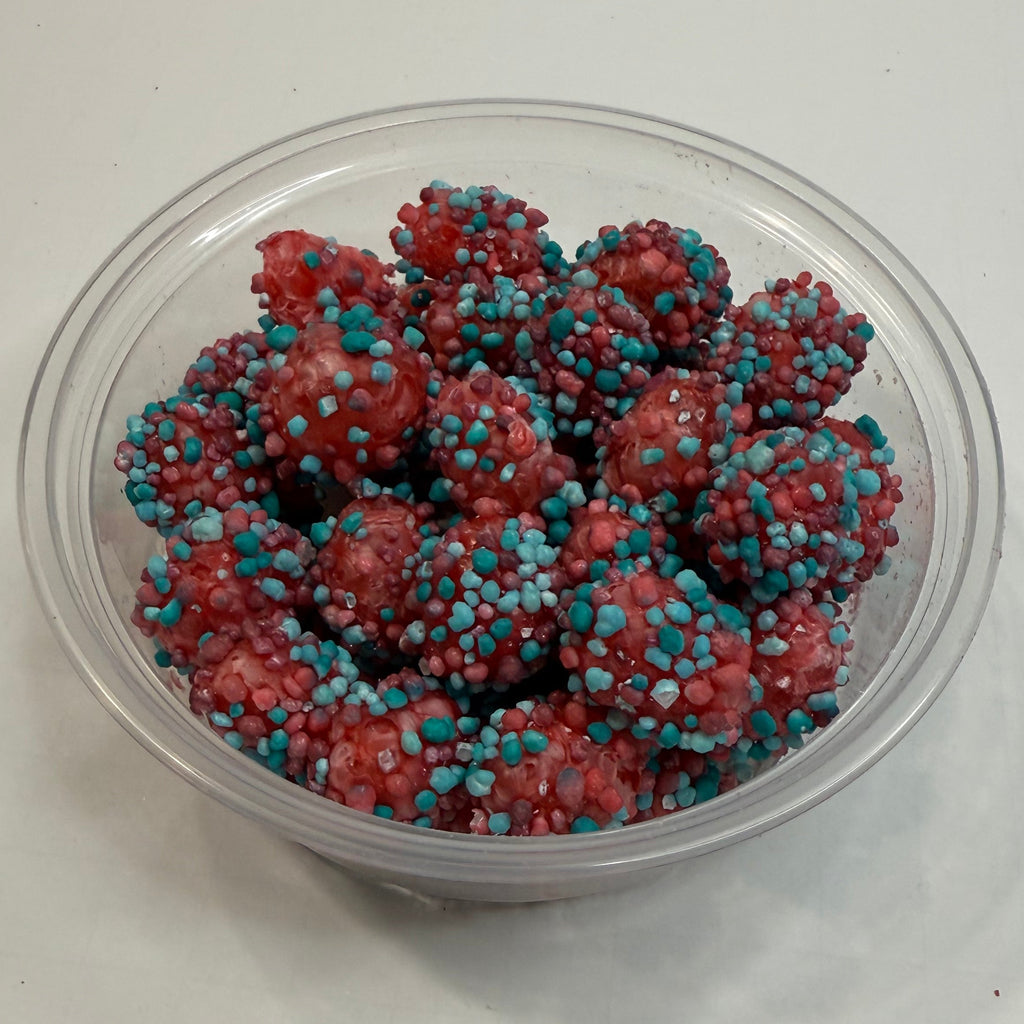 Clear container with freeze dried berry blue nerds gummy clusters on a white background