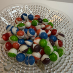 Freeze dried berry skittles on a textured glass plate