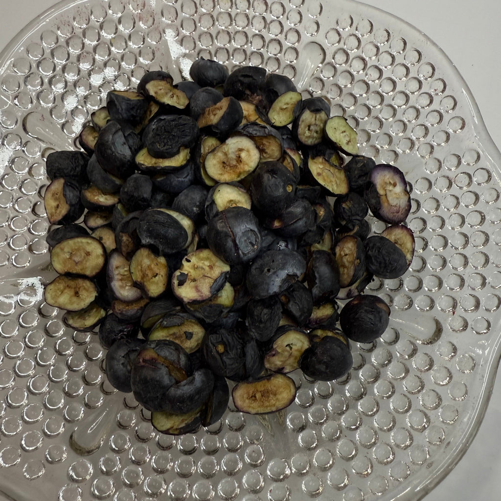 Freeze dried blueberries on a textured glass plate