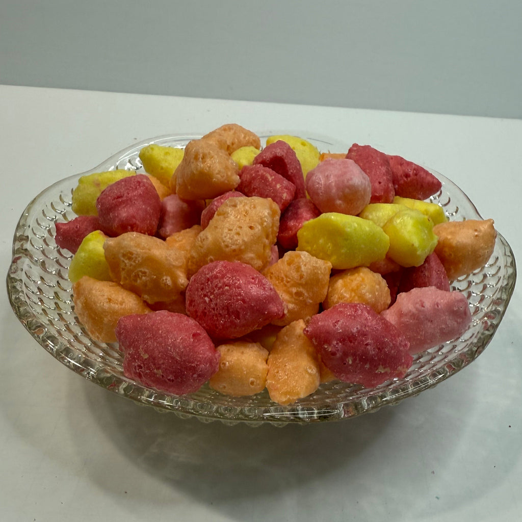 Freeze dried starburst pieces on a glass plate against a white background
