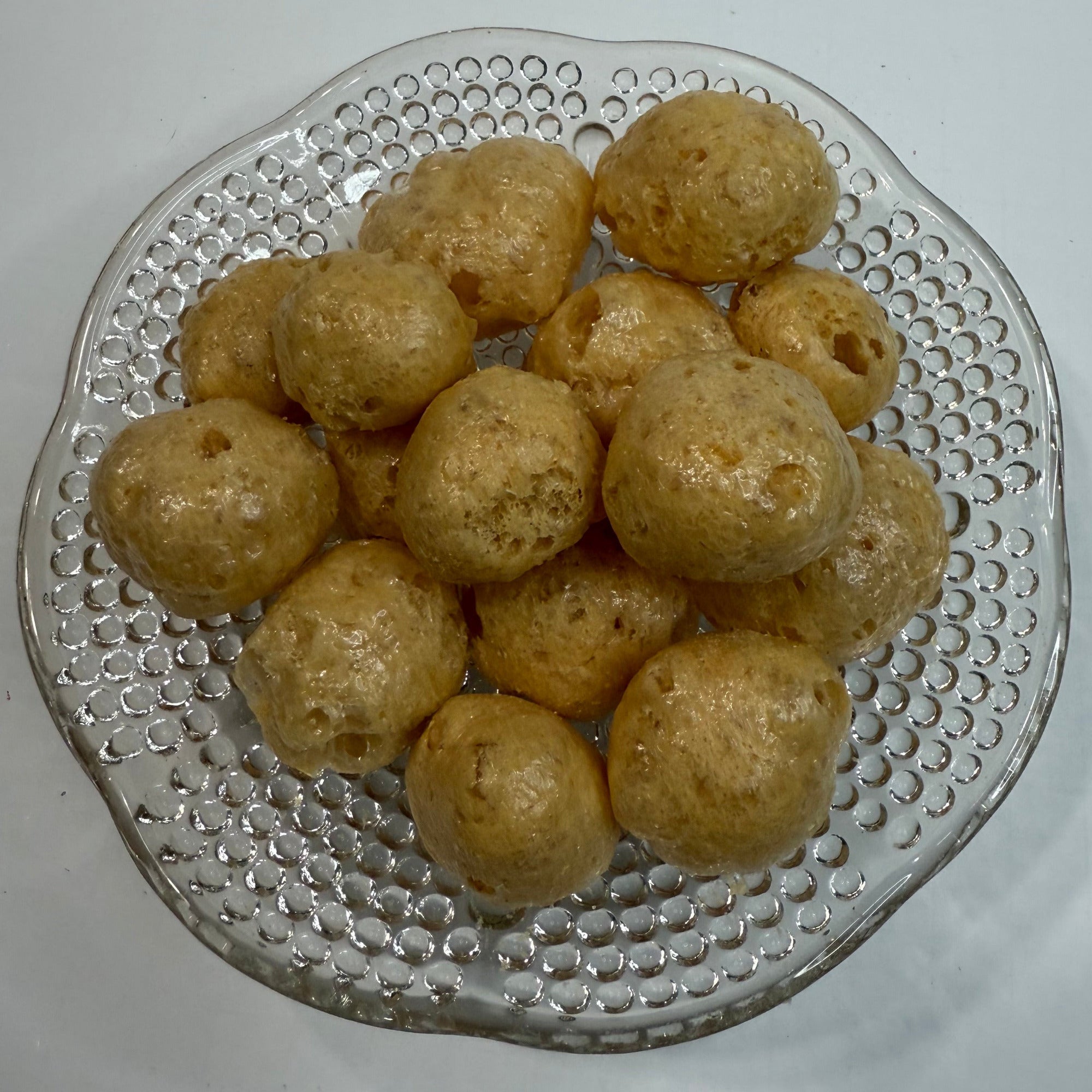 Glass plate with freeze dried caramels on a white background