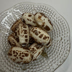 Glass plate with freeze dried chocolate chews on a white background