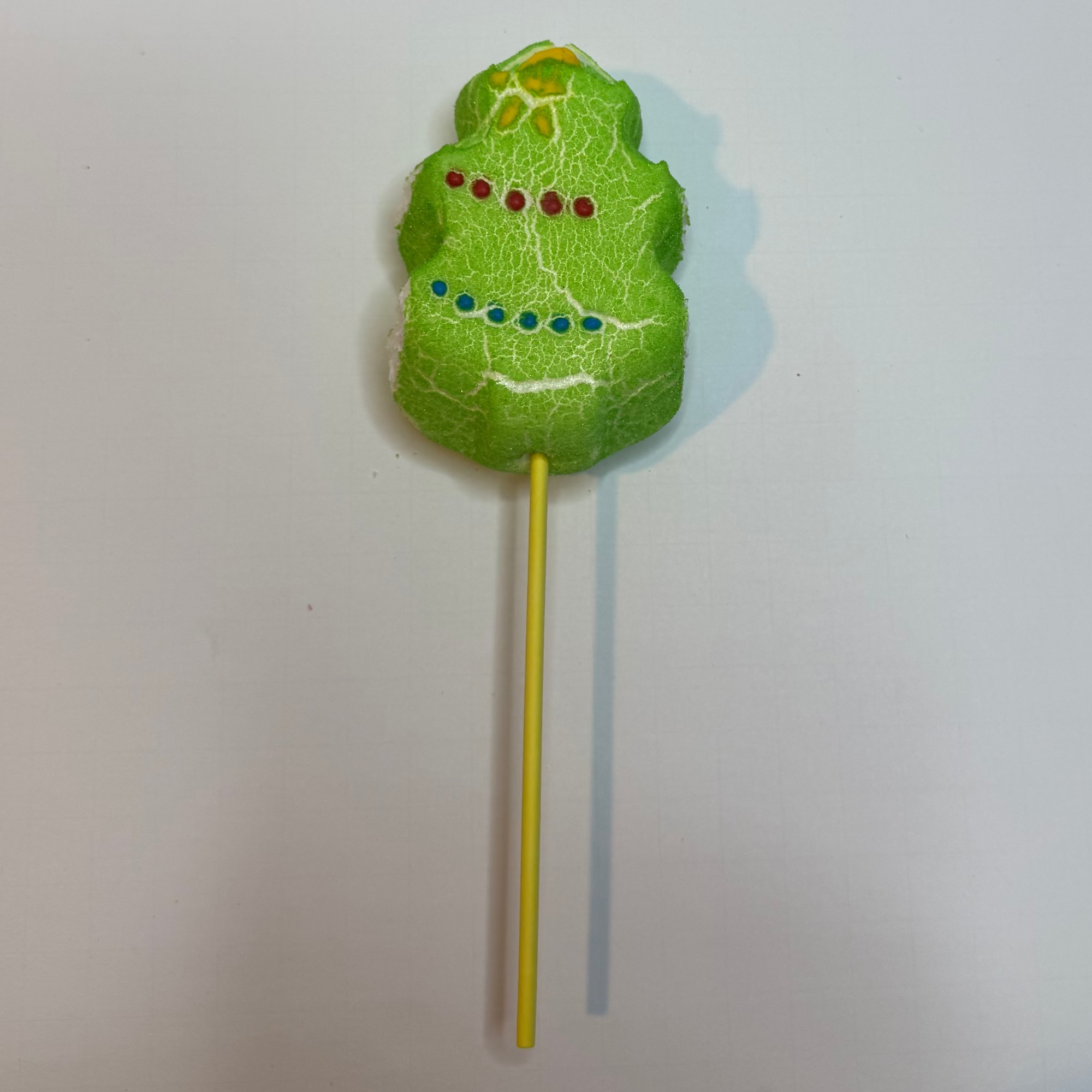 Freeze dried christmas tree peep on a stick with a white background