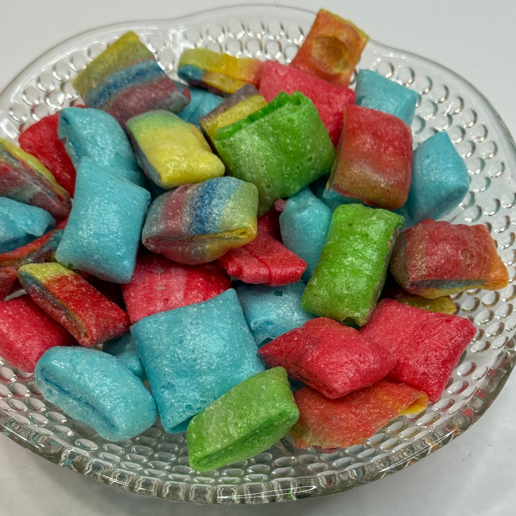 Freeze dried fruit rollup bites on a decorative glass plate.