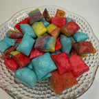 Freeze dried fruit rollup bites on a textured glass plate
