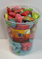 Clear container filled with freeze dried fruit rollup bites on a white background