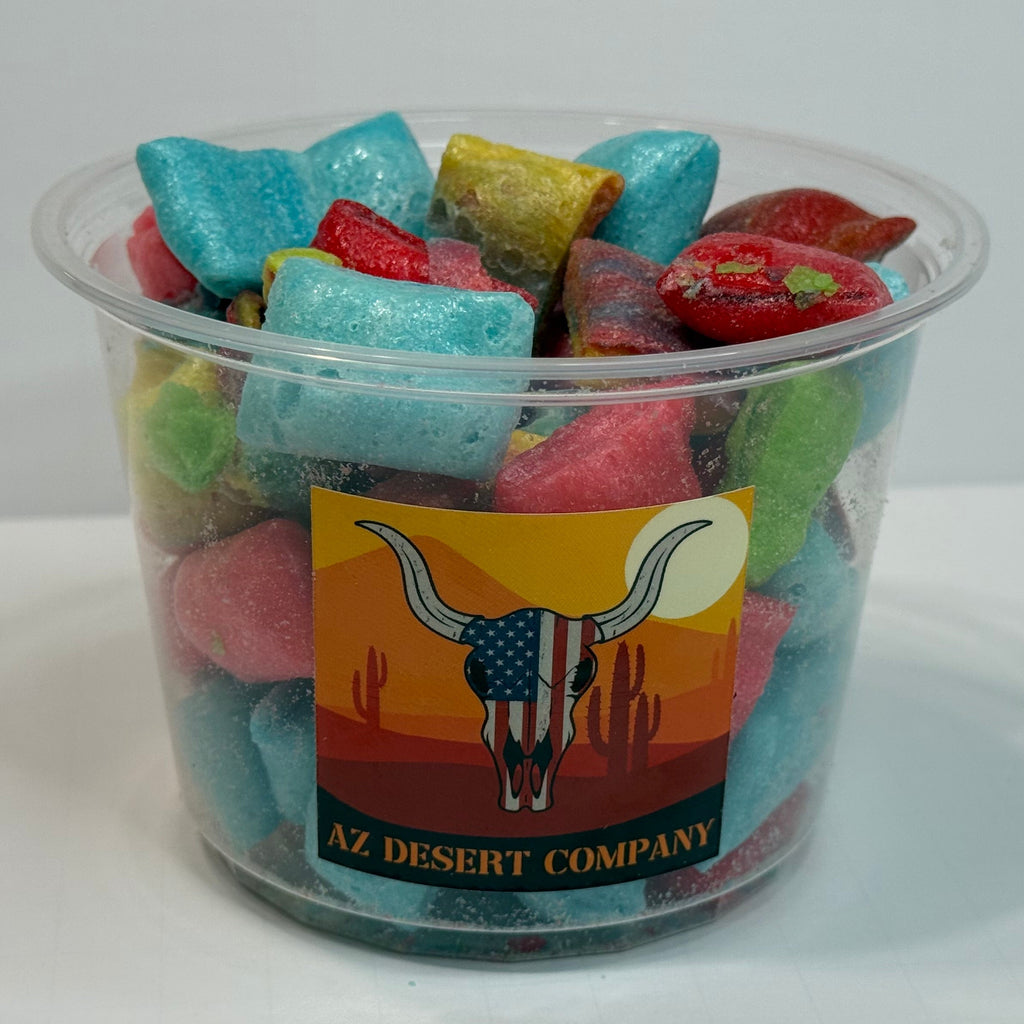 Clear plastic cup filled with freeze dried fruit rollup pieces on a white background, featuring an 'AZ Desert Company' label.