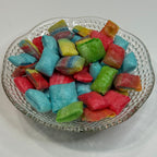 Freeze dried fruit rollup bites on a glass dish with a white background