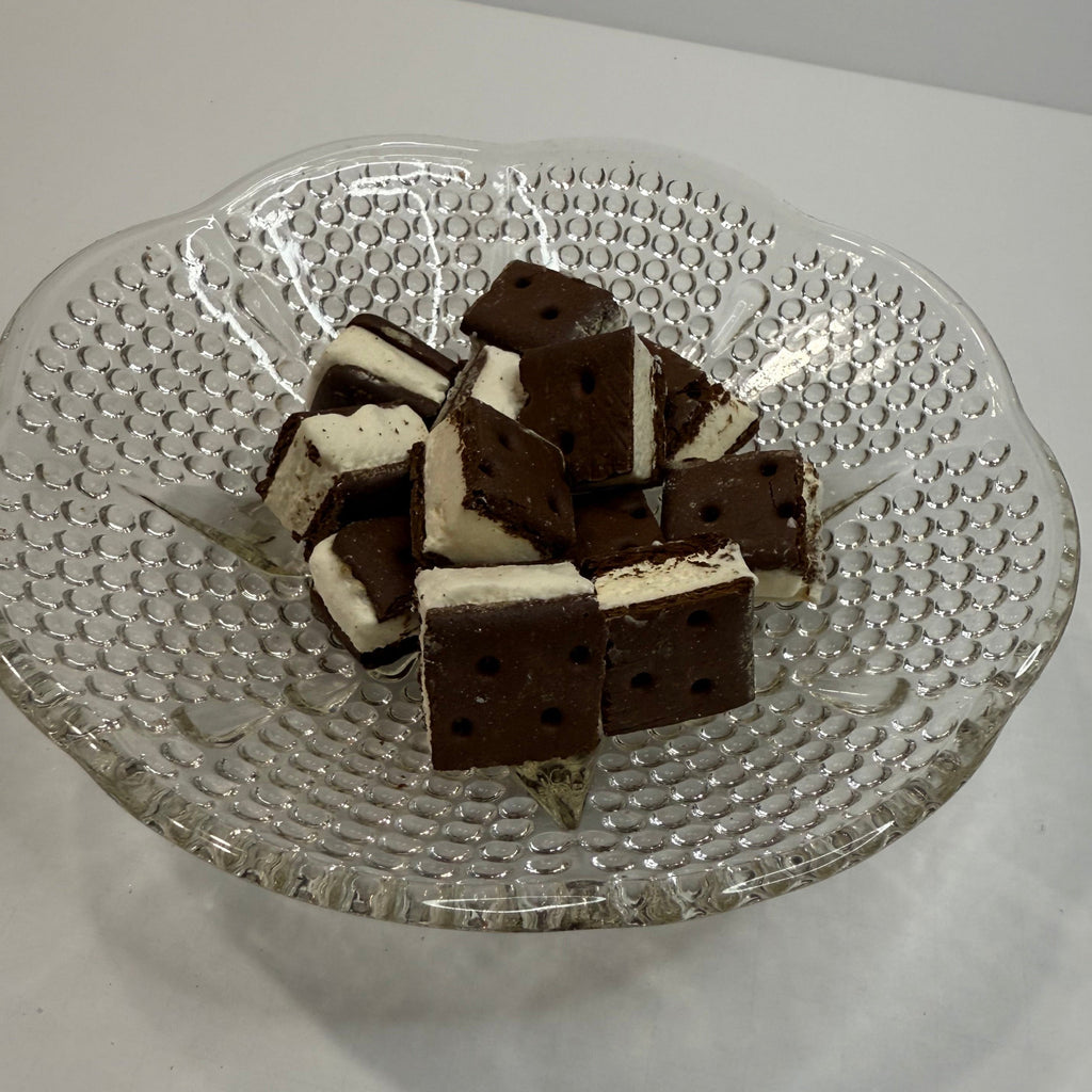 Glass plate with freeze dried ice cream sandwich bites on a white background