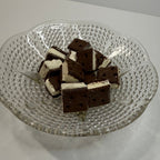 Glass plate with freeze dried ice cream sandwich bites on a white background
