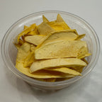 Clear plastic container with freeze dried mango slices on a white surface
