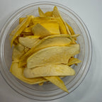 Clear container with sliced freeze dried mango on a white background