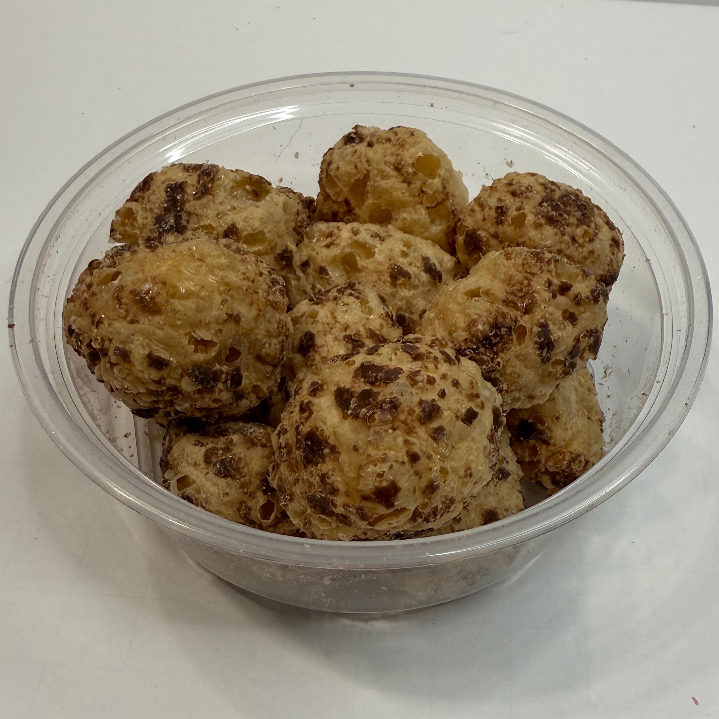 Clear container with freeze dried milk dudz on a white background