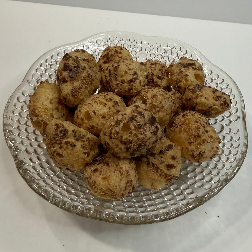 Glass plate with freeze dried milk dudz on a white background