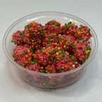 Clear container filled with freeze dried nerds gummy clusters on a white background