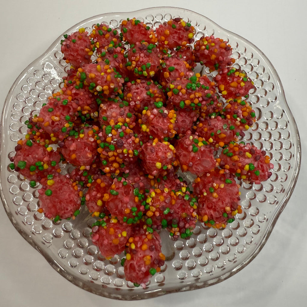 Freeze dried nerds gummy clusters on a textured glass plate.