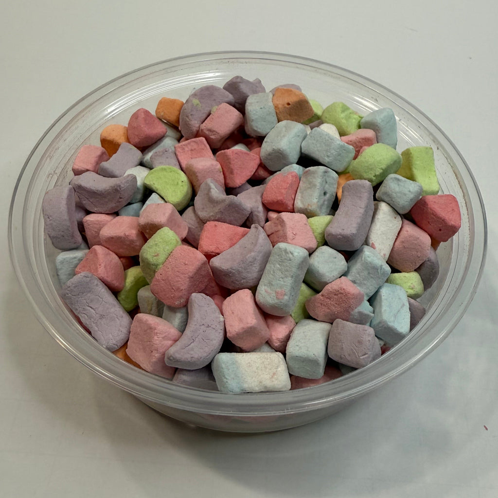 Colorful freeze dried marshmallows in a clear container on a white background