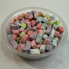 Colorful freeze dried marshmallows in a clear container on a white background