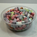 Clear container filled with colorful freeze dried marshmallows on a white background