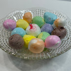 Colorful freeze dried salt water taffy on a clear glass plate with a white background