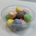 Clear plastic cup filled with freeze dried salt water taffy on a white surface