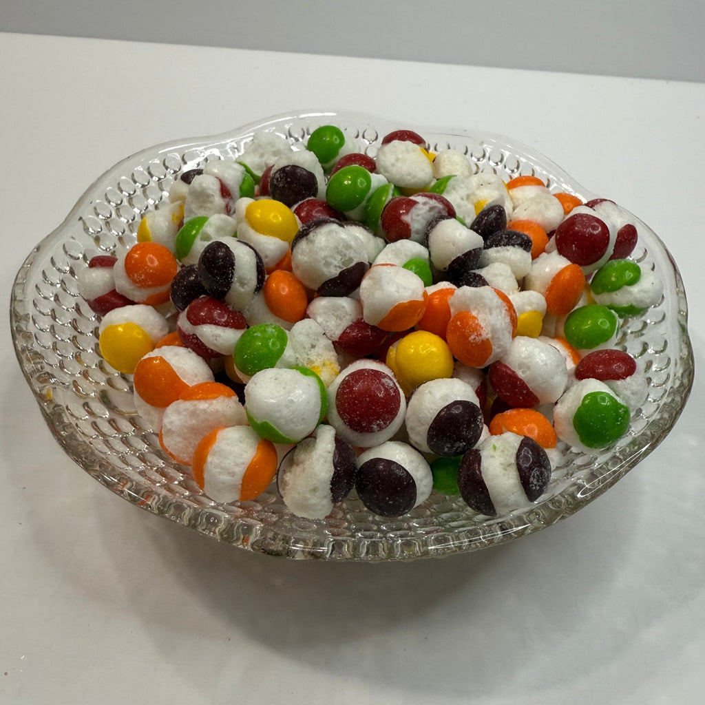 Freeze Dried Skittles on a glass tray with a white background