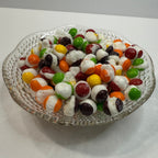 Freeze Dried Skittles on a glass tray with a white background