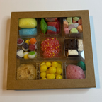 Box of assorted colorful candies on a white surface