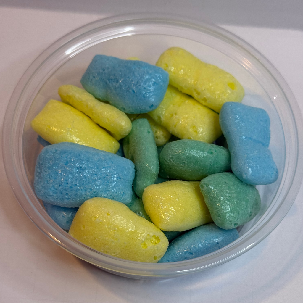 Clear container with freeze dried sour air headz on a white background