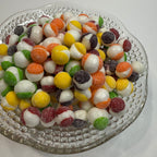 Freeze dried sour skittles on a textured glass plate
