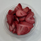 Clear container with freeze dried strawberry pieces on a white background
