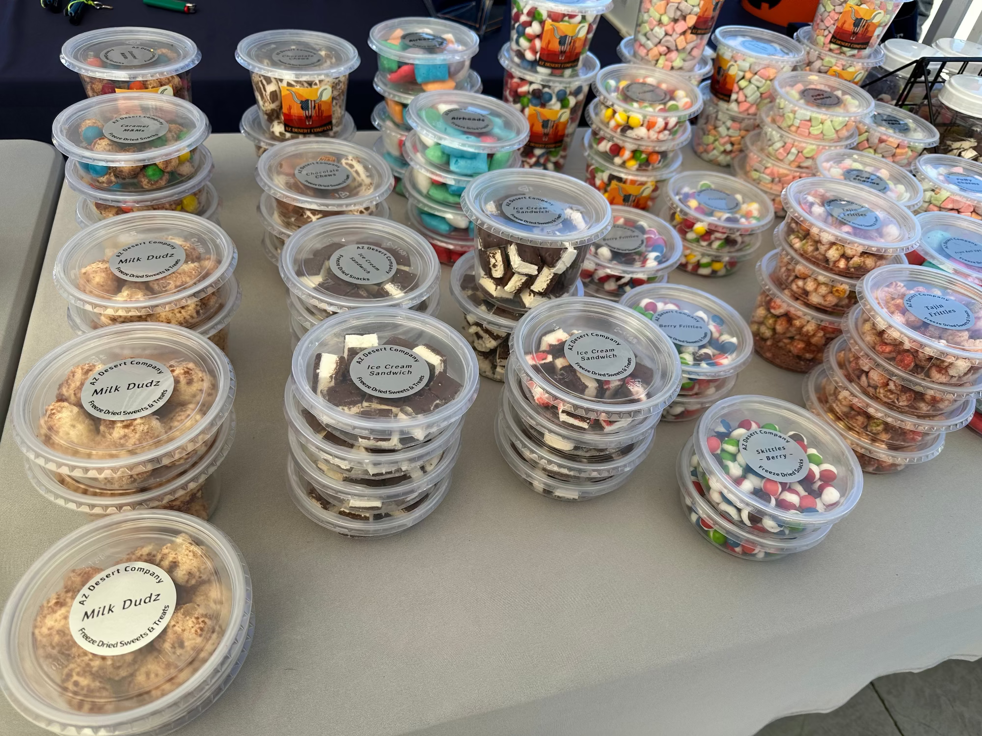Assorted small containers with freeze dried snacks on a table